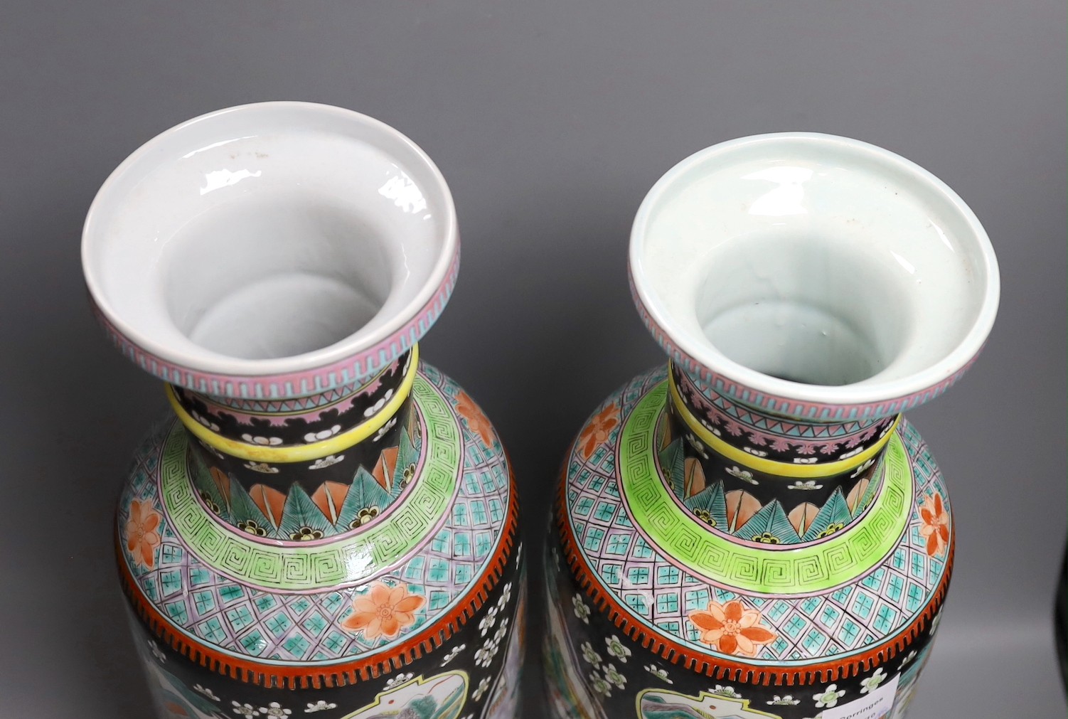 A near pair of Chinese black ground rouleau vases. 47.5cm high